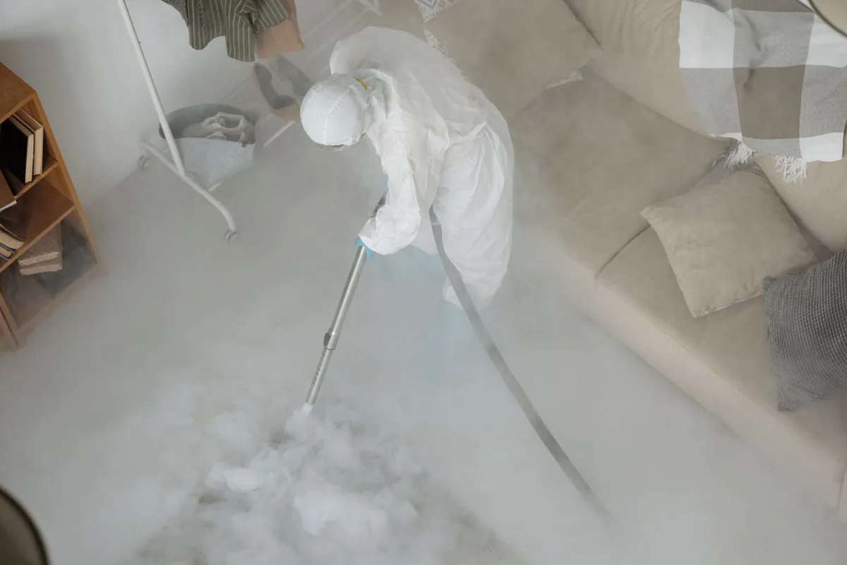 Biohazard cleanup technician in protective equipment, Durham, CT
